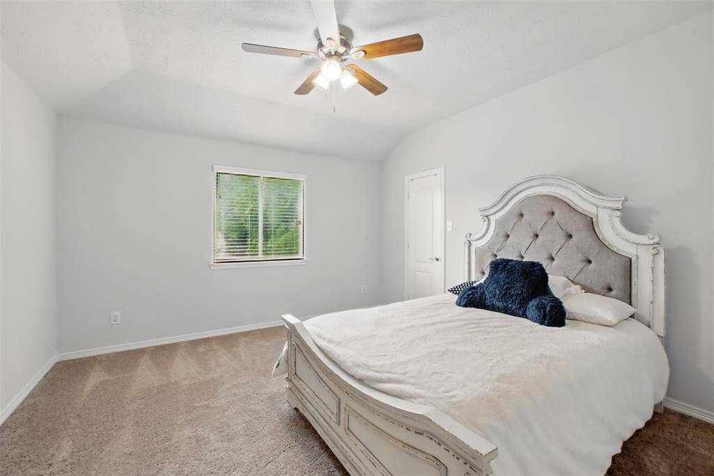 Secondary bedroom with a nice closet, ceiling fan, new paint and carpet.