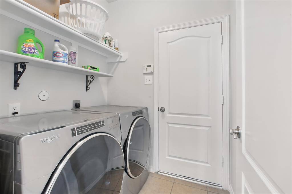 Utility room with shelving for storage.