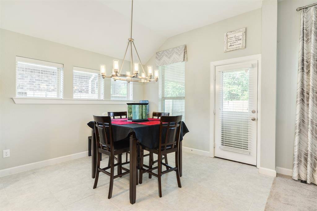 another view of the dining area and the backdoor leading out to the covered patio