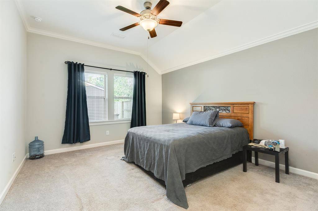 primary bedroom is spacious with windows over looking the back yard