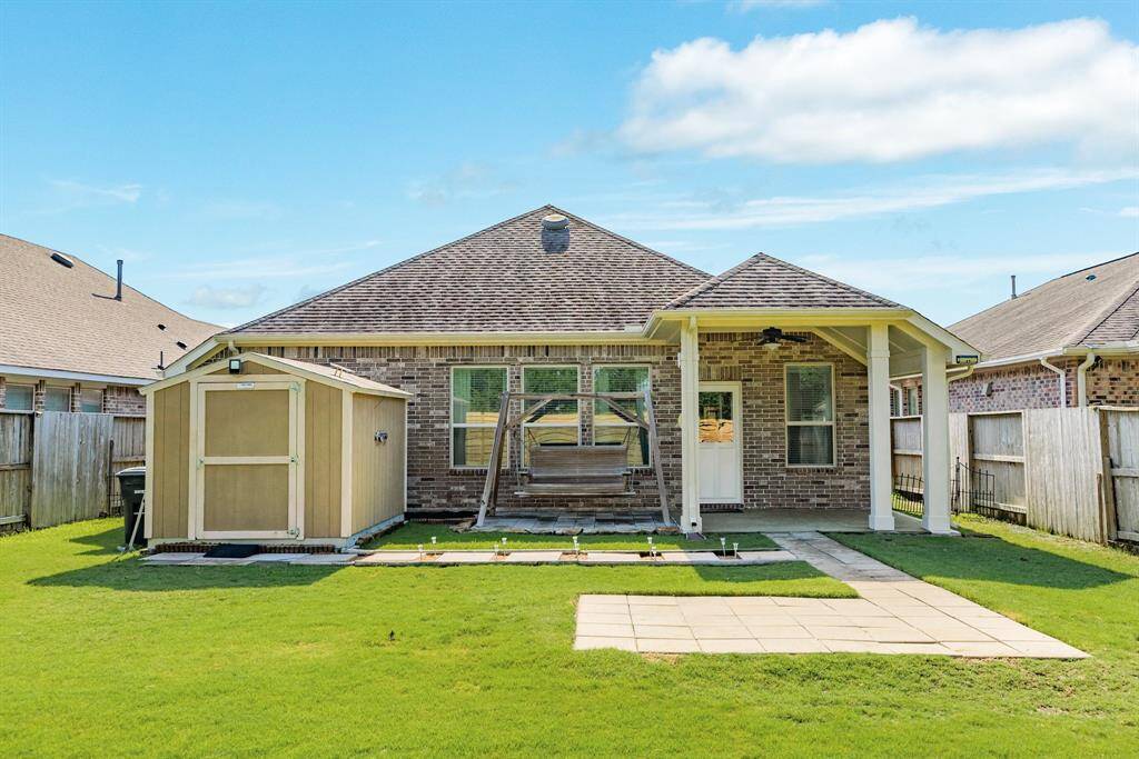 this is an all brick home with a covered patio a storage shed and swing stays with the home
