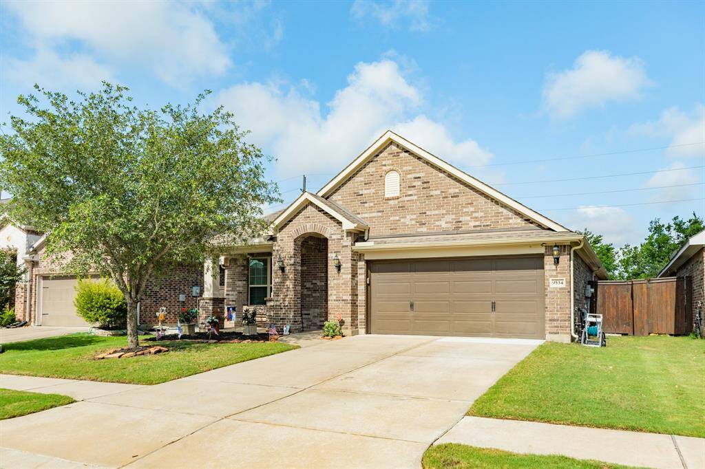 view of the front showing the great landscaping, flower bed, enjoy sitting on the front porch