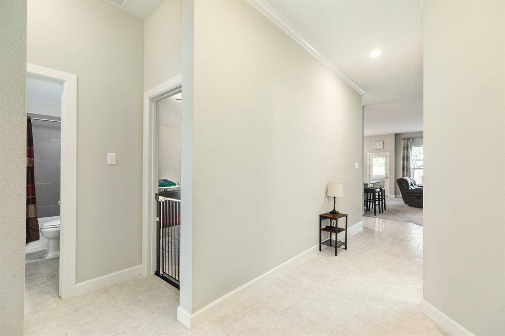 from this view you can see one bedroom door and the bathroom and the hallway towards the family area