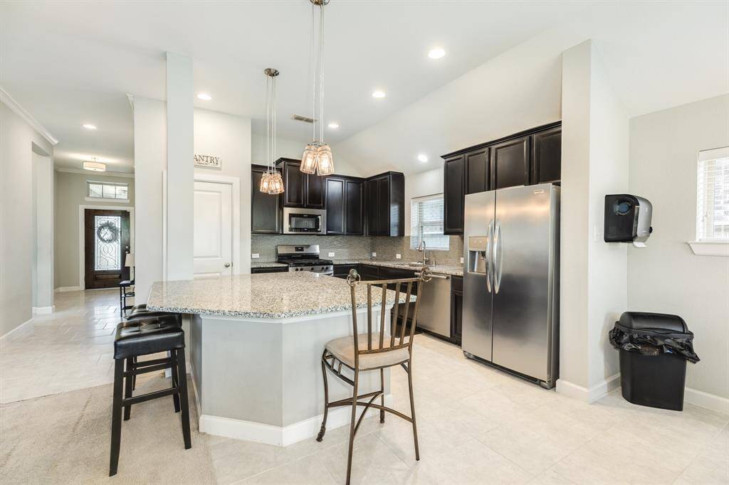 here you can see how the hallway seamless flows right into the kitchen and family room