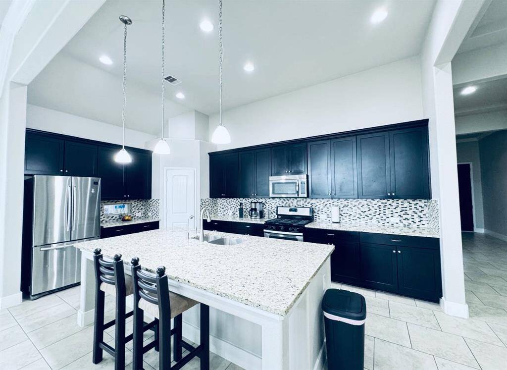 Spacious, modern kitchen with sleek open layout and elegant finishes.