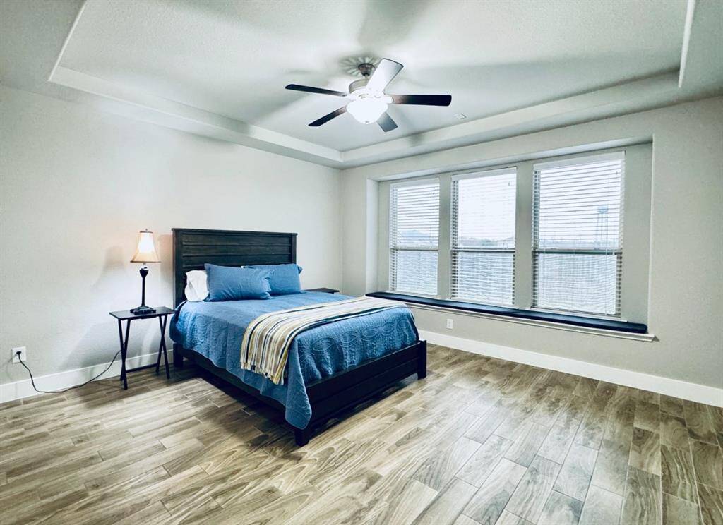 Expansive master bedroom with abundant natural light.