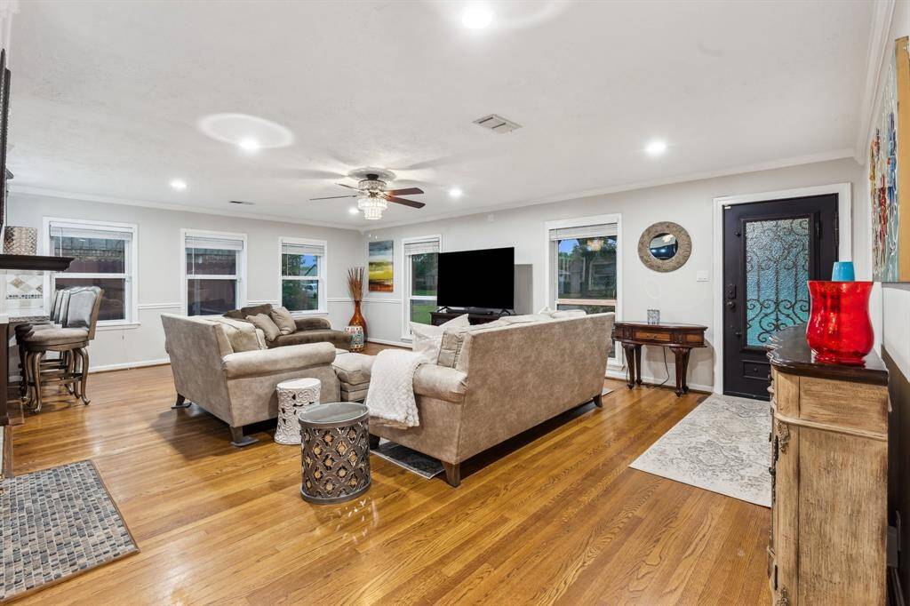 This living area offers incredible flexibility with a layout that supports everything from casual family nights to formal entertaining. The central placement of the fireplace adds both function and visual interest.