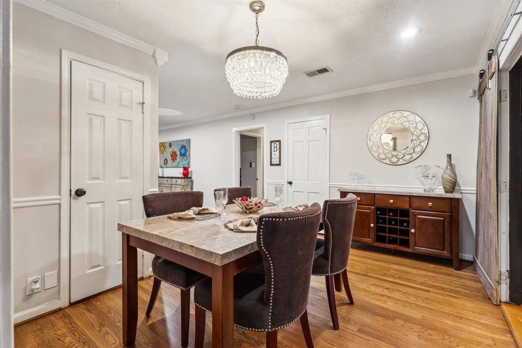 Perfectly positioned between the kitchen and living room, the dining space is well-lit, spacious, and accented with crown molding and timeless hardwood floors.