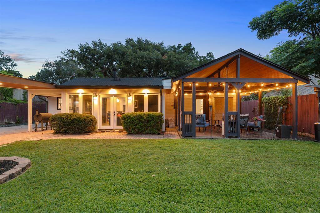 Whether hosting or relaxing, the covered patio offers shade, comfort, and a stylish connection to the beautifully maintained backyard.