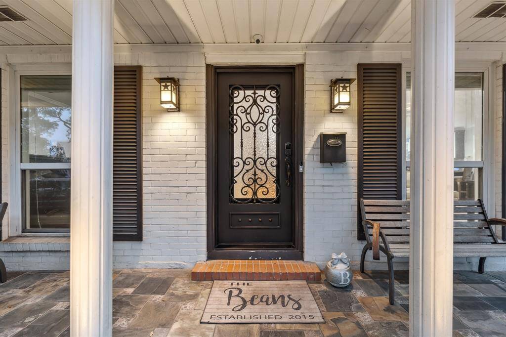 The open layout welcomes you with a clear line of sight from the front door to the dining area and beyond. Rich oak flooring flows seamlessly into a versatile sunroom/flex space, framed by beautiful sliding barn doors for added privacy and charm.