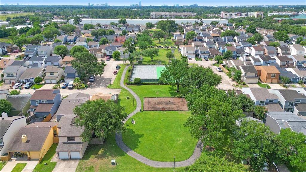 The tennis court and playground is surrounded by a jogging/walking path.