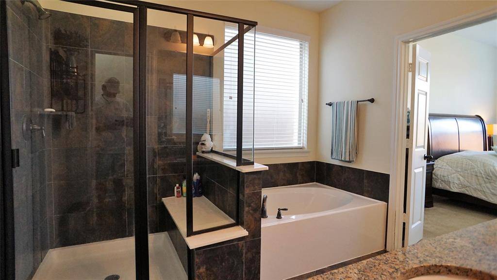 Master Bathroom with walk in shower, bench and garden tub.
