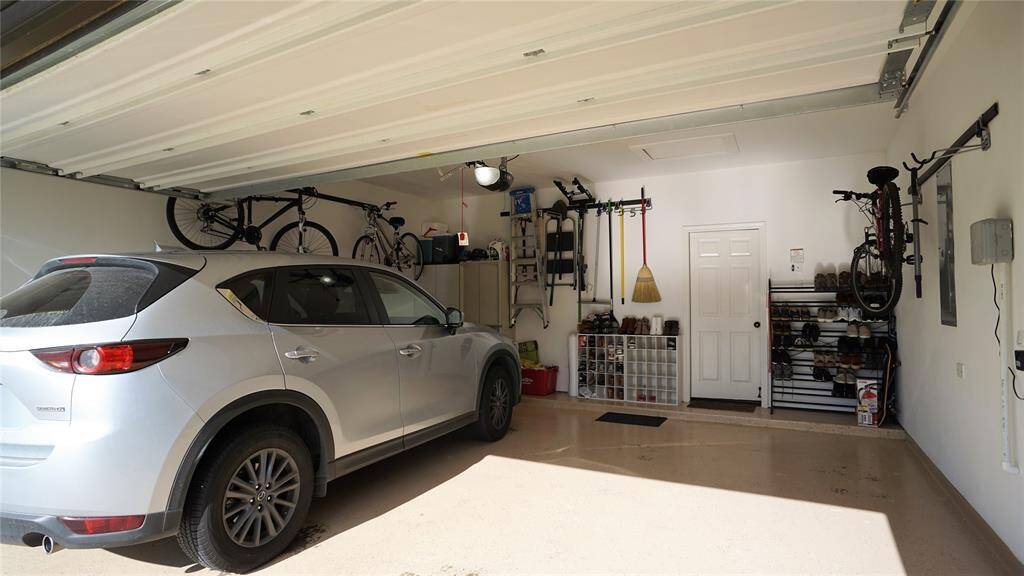 Garage has epoxy coated floor and storage racks for a clean, organized garage.