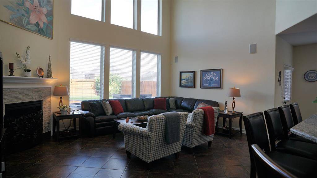 Large open living room with gas fireplace, and tile floors through out most of downstairs living space except master bedroom and study.