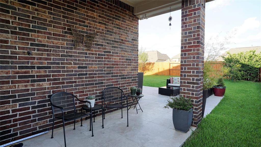 Step out to this nice back yard space with tiled patio.