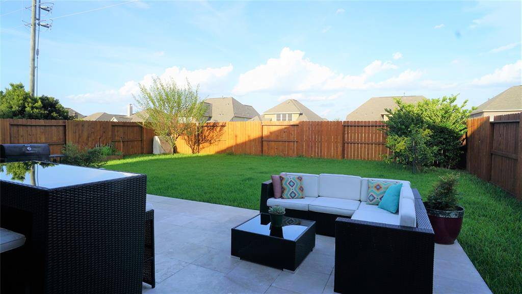 No immediate back neighbors.  Backyard faces east so will get afternoon shade. Stained fence and well kept green lawn make for a truly nice and usuable backyard space.