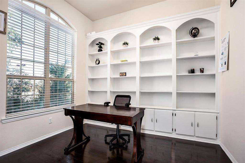 Office with built-ins and wood floors