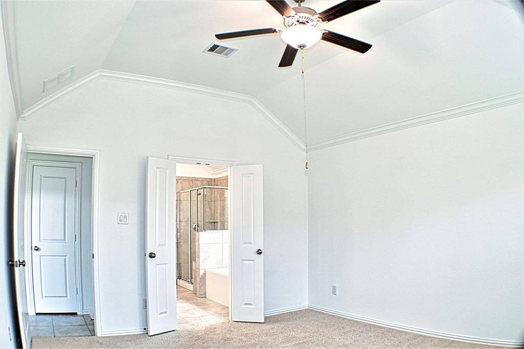 Opposite view of the primary bedroom, looking into the bathroom suite