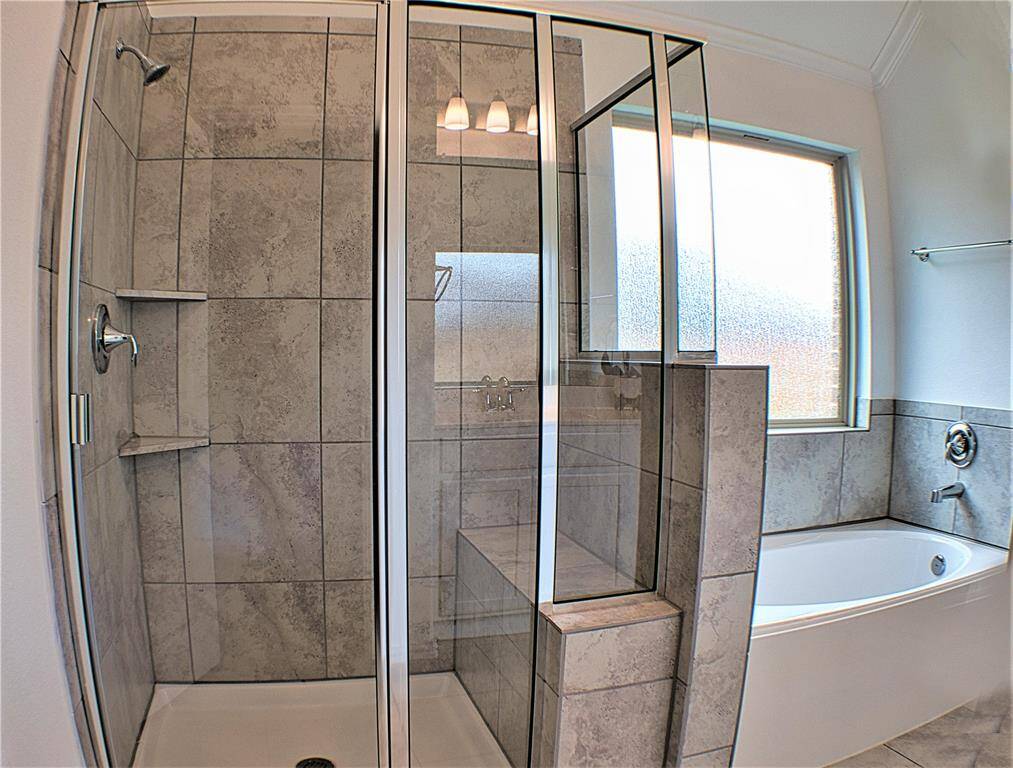 Stand up shower with built in shelves and soaking tub