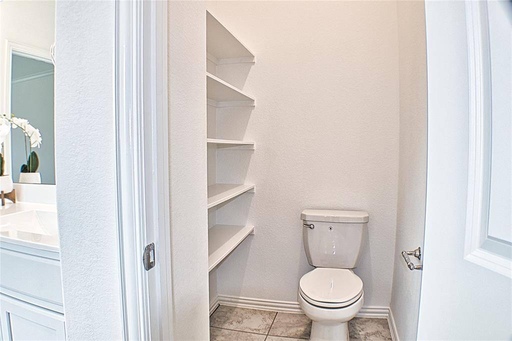 More storage and built in shelving in the primary bathroom suite