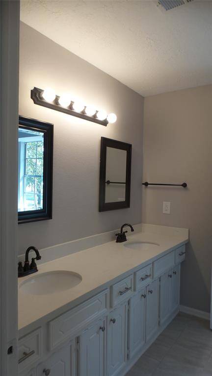 Make the mornings easier with the upstair bath with it's double sinks & separated area w/bath tub & commode.  Lots of cabinet space!