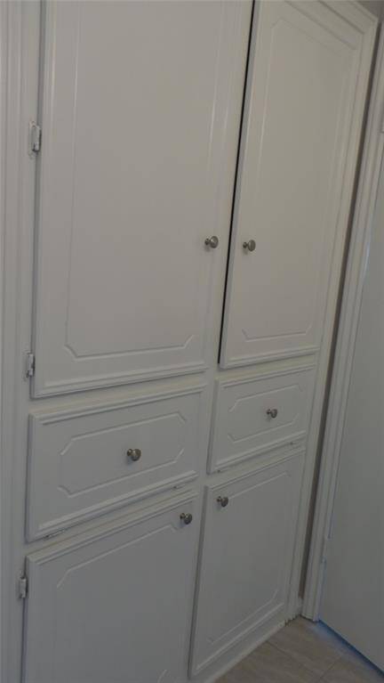 Upstair bath has builtins with plenty of room for linens & towels.  Below is a dual laundry hamper for separating clothes.