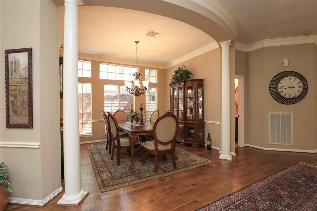 Formal dining room with windows looking out to atrium