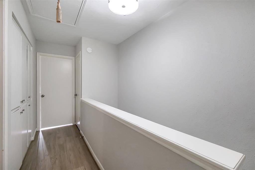 Upstairs find a landing space between the two bedrooms with additional cabinet space on the left side.