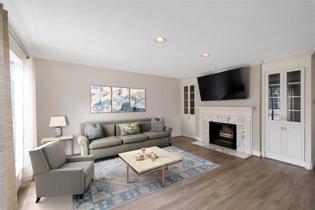 Great living room space with a fireplace, and custom built ins on either side.Virtually Staged