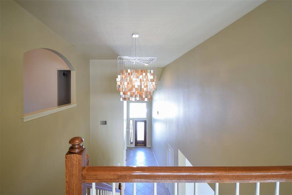 View from catwalk back to front door. Caprice Chandelier is just one of the many upgraded light fixtures