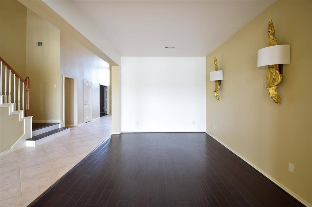 Formal dining room with customized wall sconces and hand scraped wood floor