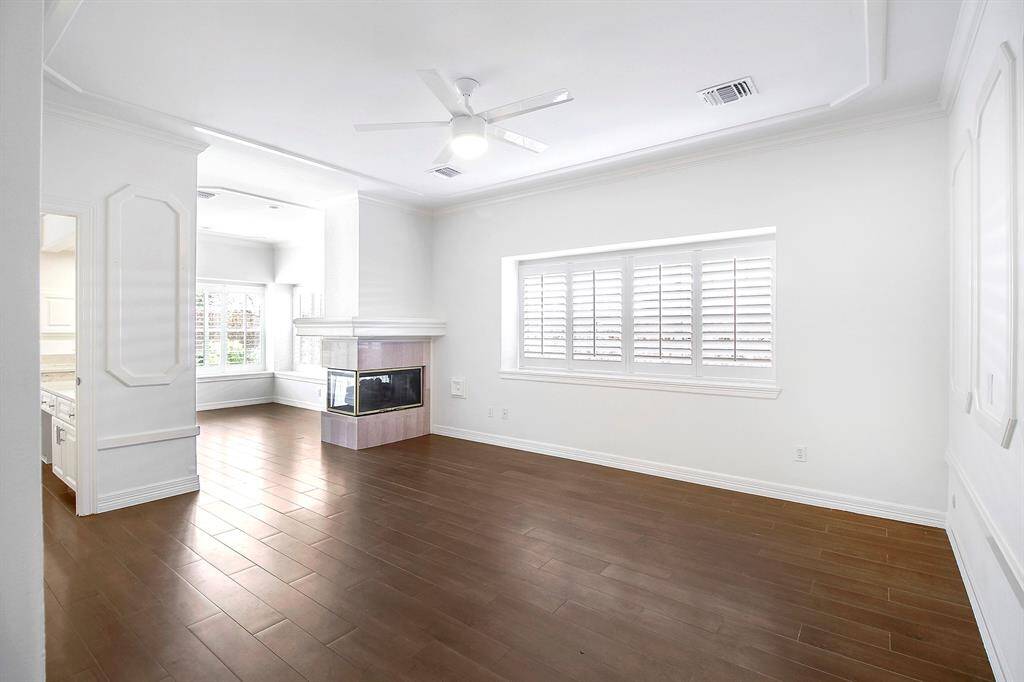 The primary bedroom has a living area with a fireplace. This space can also be used as a home office.