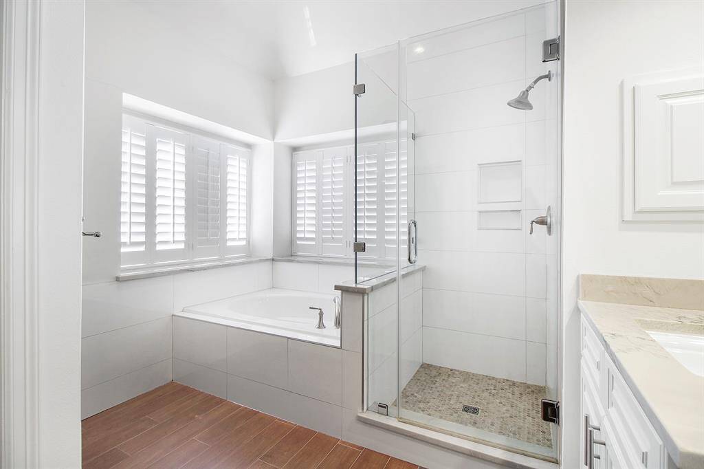 Primary bathroom with tub and walk-in shower.