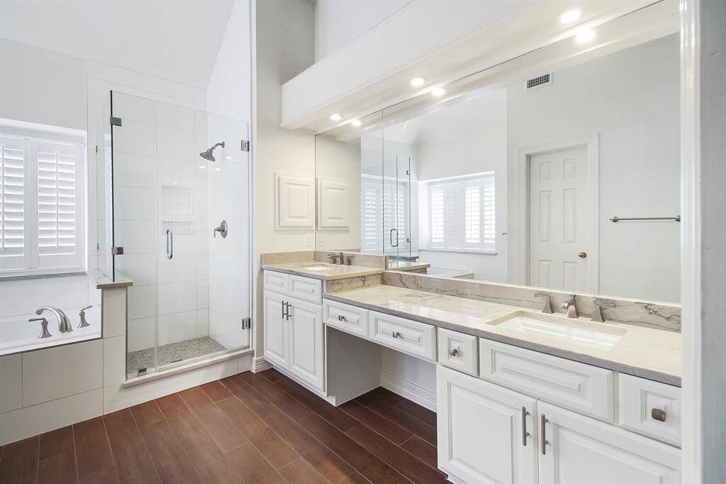Dual vanities in this beautifully updated primary bathroom.