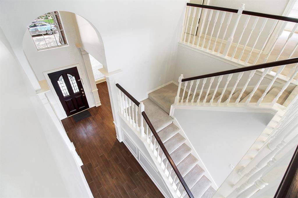 The staircase leads to the second floor, with a game room and three secondary bedrooms.