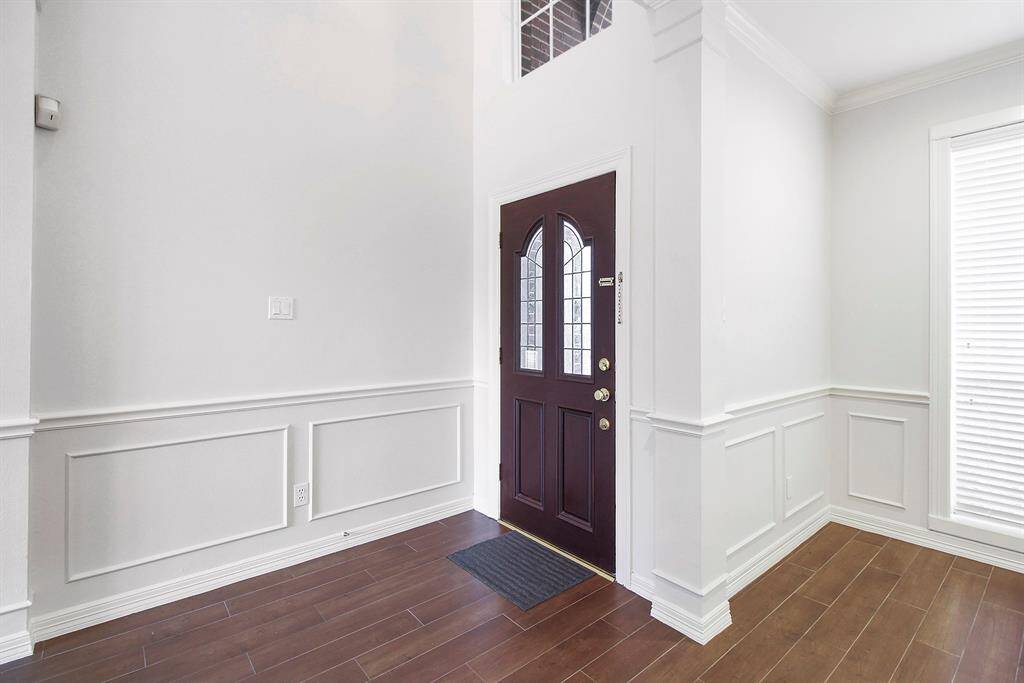 Inviting entrance. To the right is a formal living and dining area.