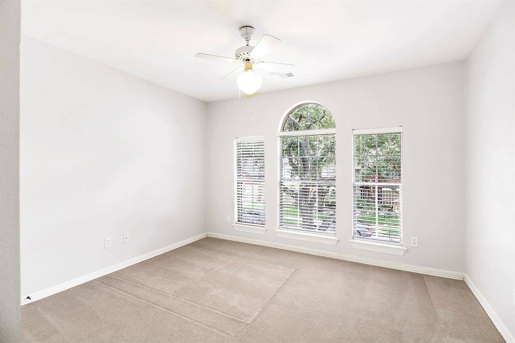 View of bedroom 1 with ceiling fan.