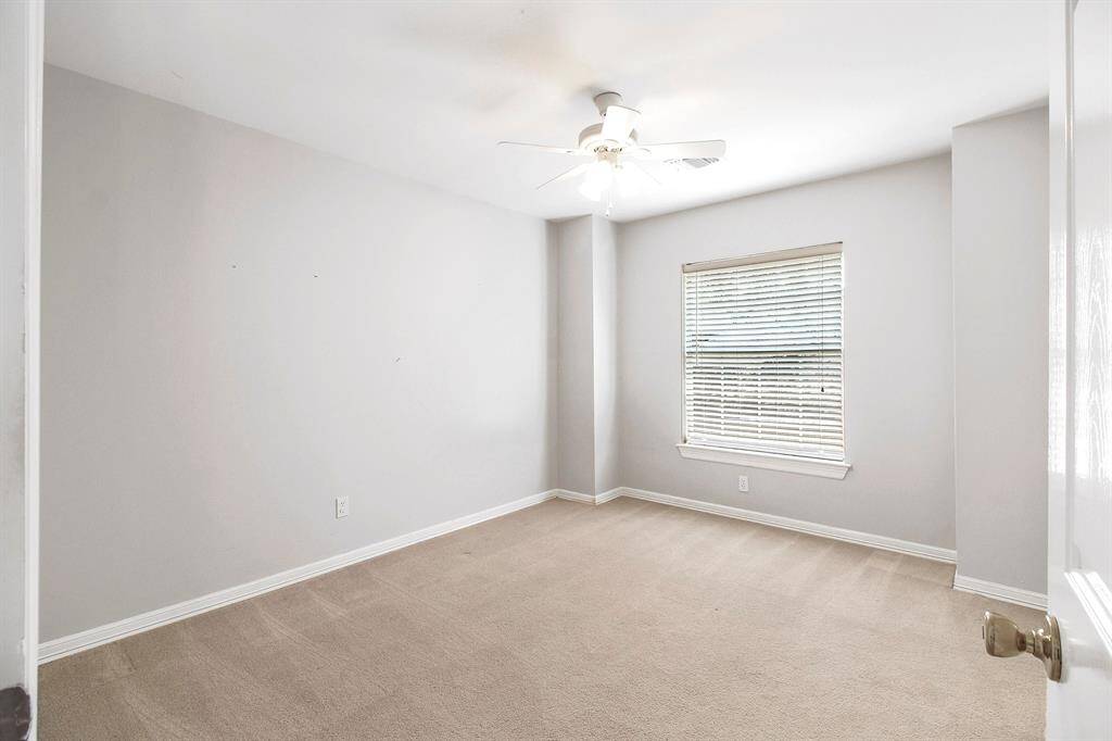 View of bedroom 2 with ceiling fan.