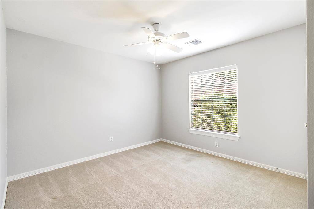 View of bedroom 3 with ceiling fan.