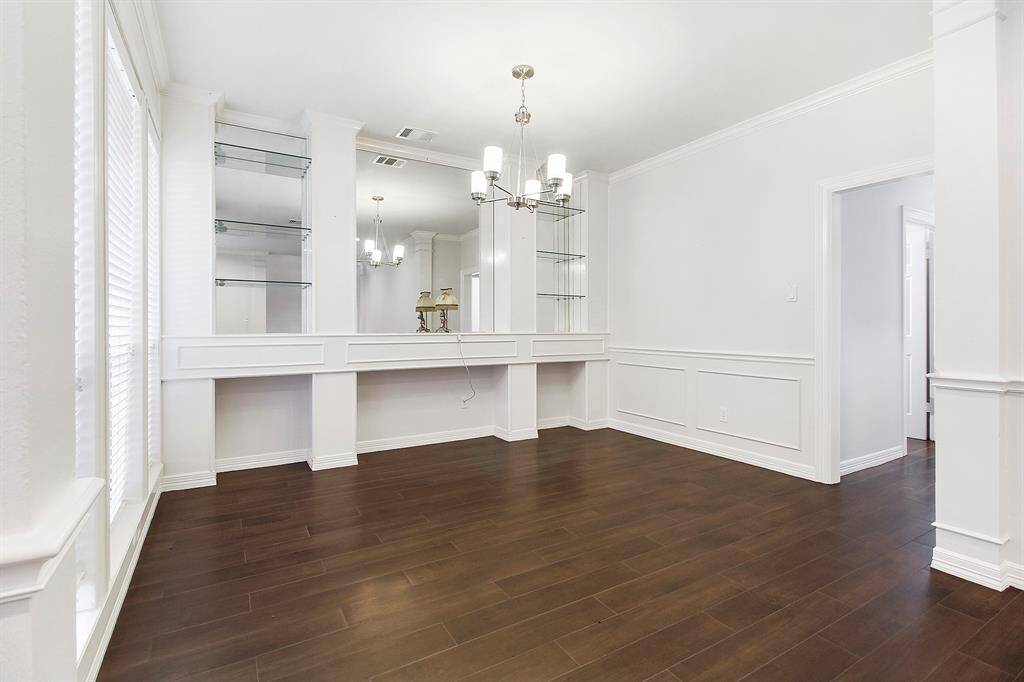 Another view of the formal dining room which leads to the kitchen. Contemporary light fixture.