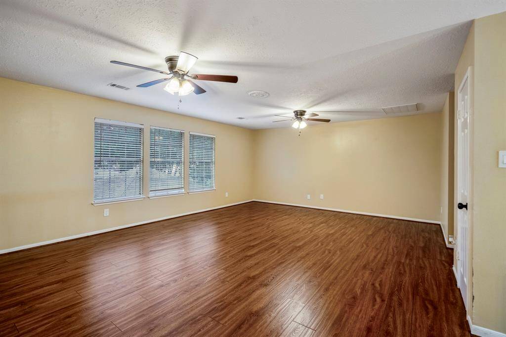 And now… check out the huge game room! There's plenty of space for a pool table, maybe a ping pong setup—or go all out and create your own home theater. It’s your space to play, relax, and entertain!