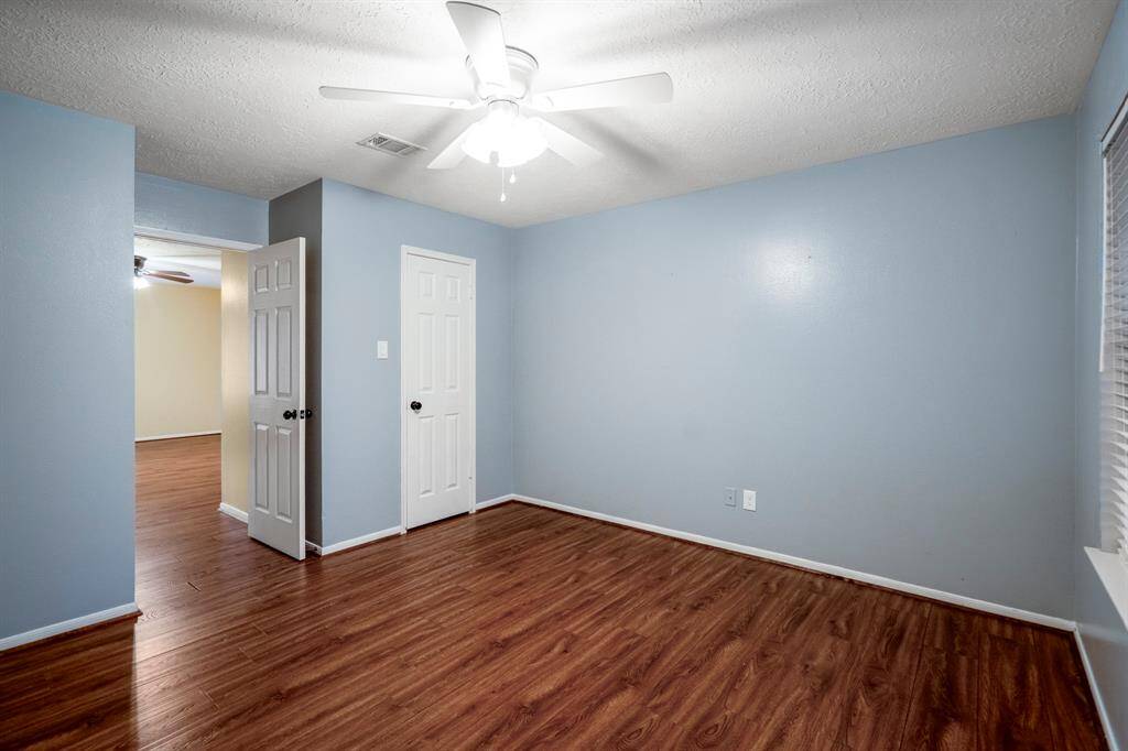 Here’s a look at bedroom number 2—located upstairs, featuring a spacious walk-in closet and zero carpet for easy upkeep and a sleek, clean feel.