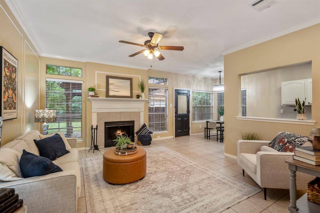 Um, hello there, you adorable living room! Warm tones, tile floors, and a cozy gas fireplace set the perfect vibe for unforgettable nights snuggled up on the couch with your favorite people.