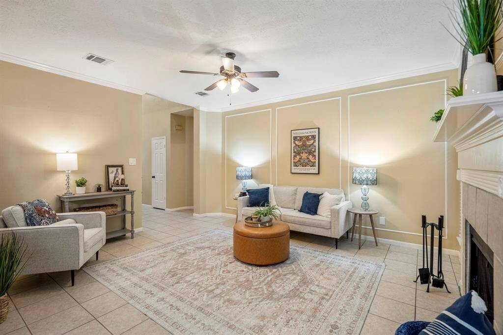 Um, hello there, you adorable living room! Warm tones, tile floors, and a cozy gas fireplace set the perfect vibe for unforgettable nights snuggled up on the couch with your favorite people.