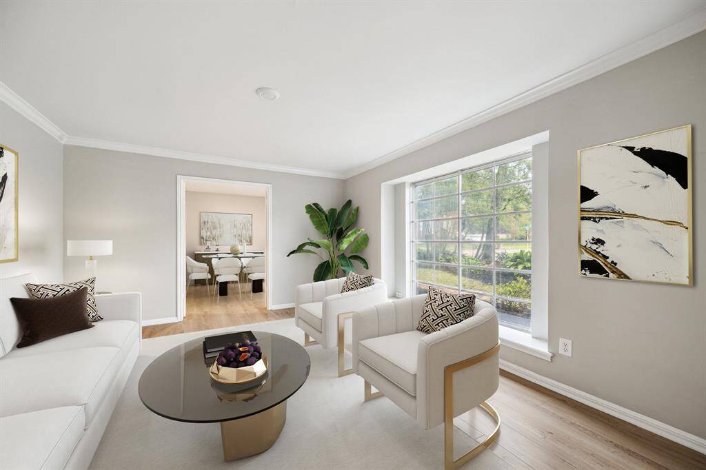 Spacious formal living room with a large window. This room is virtually staged.