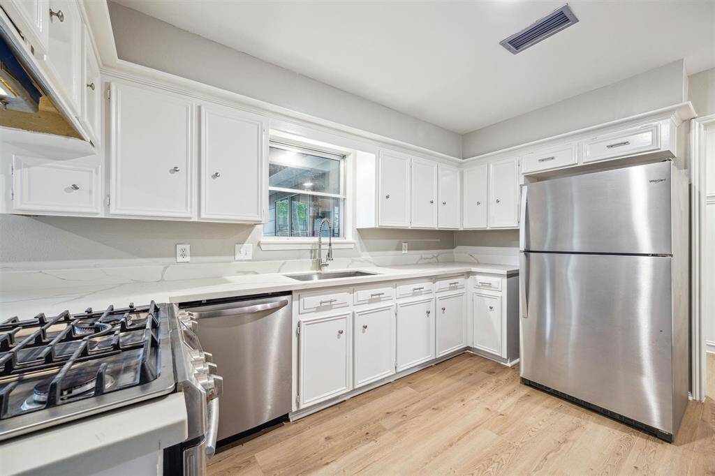 Another kitchen view with farmhouse sink.