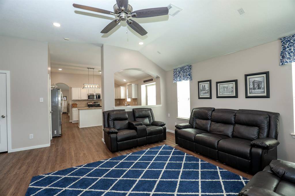 Laminate floors flow seamlessly from the front of the home to the backdoor.