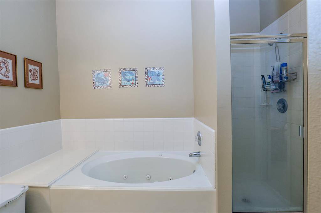 The primary bath has a jetted tub and separate shower.