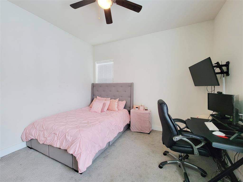 Front bedroom with a ceiling fan.