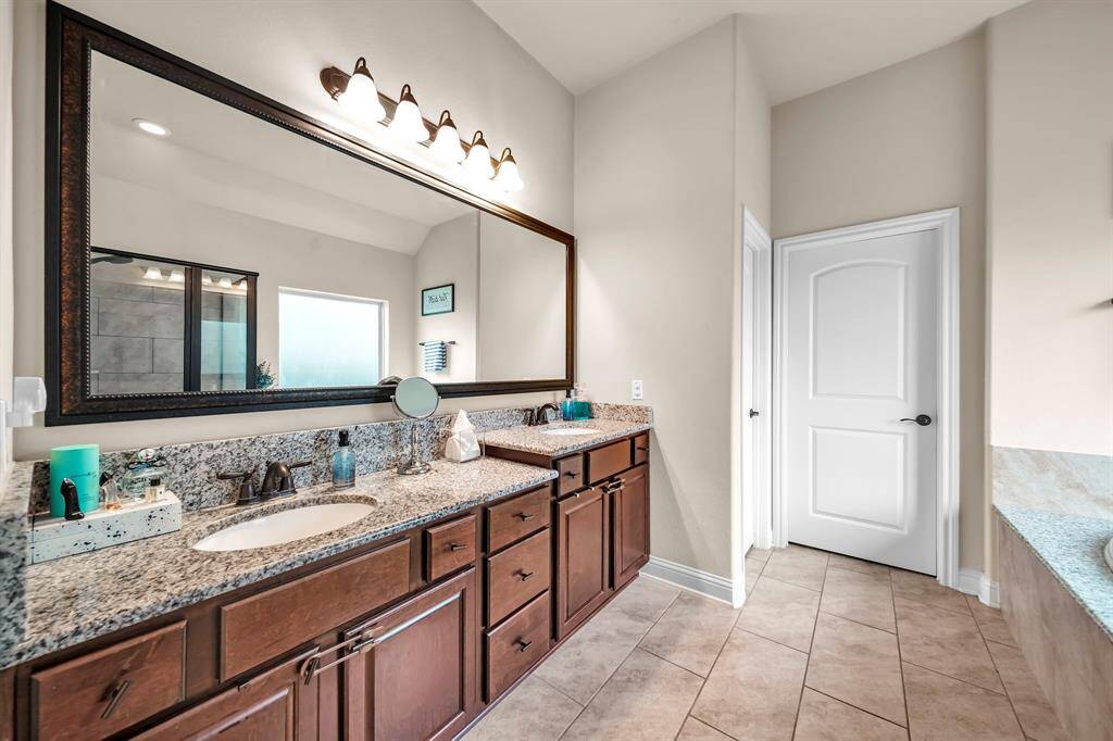 The ensuite bath includes granite counter tops, a soaking tub, separate shower, double sinks and a large walk-in closet.